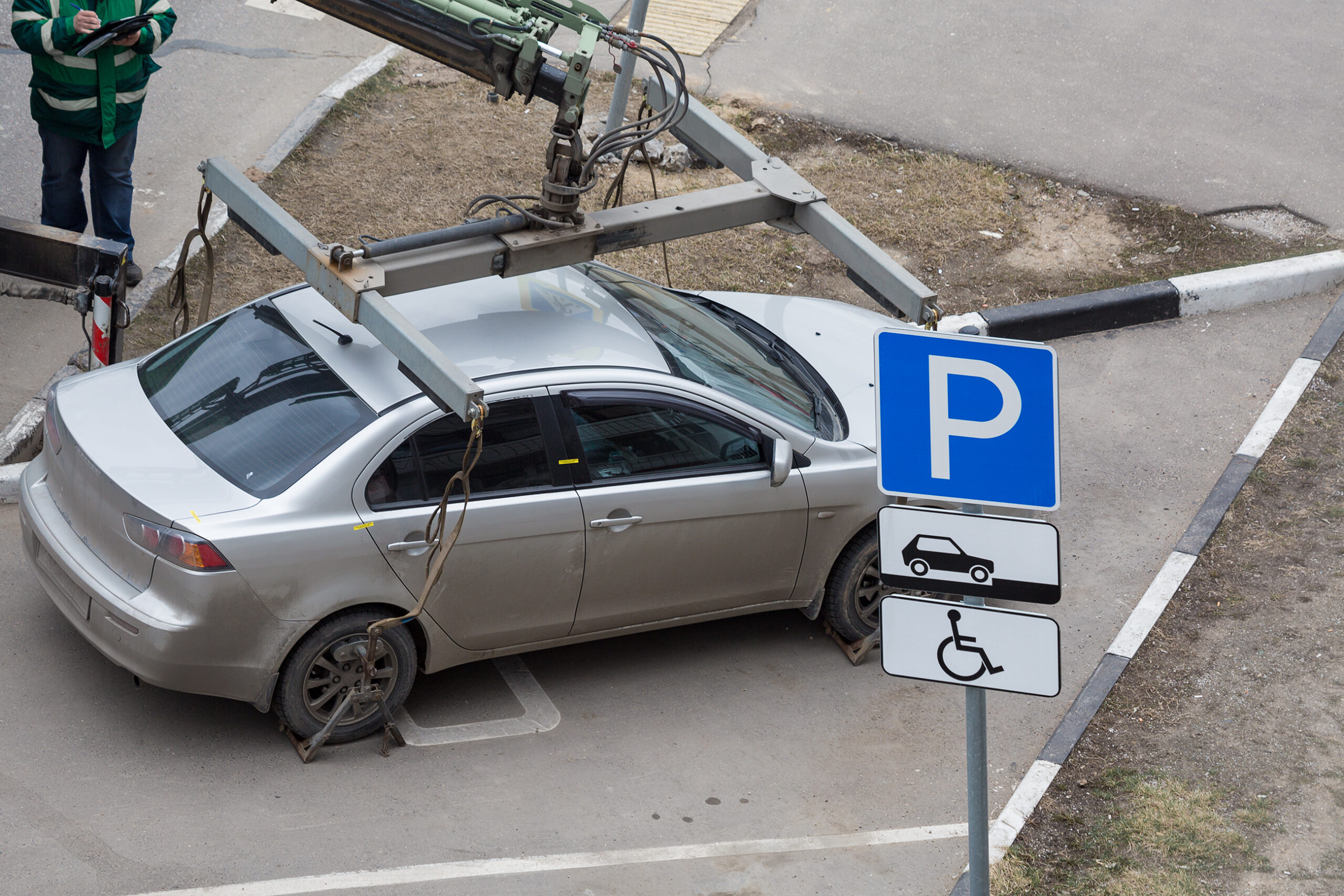 Tow Truck Loads The Car For Violation Of The Parking Rules Fixing And Lifting Mechanism Parking Sign For Disabled People